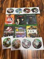 Group shot showing ten Xbox One discs in sleeves and six game cases