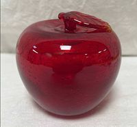 Front view of red art glass apple paperweight showing overall shape and color