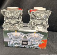 Two Mikasa Sparkling Star crystal votive candleholders on top of original box