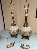 Full view of both Carl Falkenstein orb table lamps with cords visible
