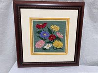 Full view of framed needlepoint artwork