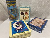 Group shot of four advertising tins
