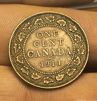 Reverse of 1914 Canadian large cent showing ONE CENT CANADA 1914 and maple leaf wreath
