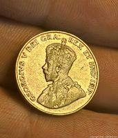 Obverse showing King George V portrait with visible scratches