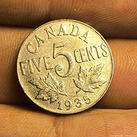 Reverse side showing CANADA FIVE 5 CENTS maple leaves and date 1935