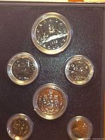 reverse sides of six 1982 Canadian coins in capsules within display holder