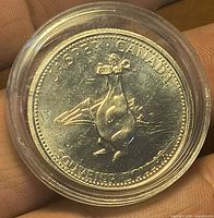 Obverse with caribou and 75 Years legend