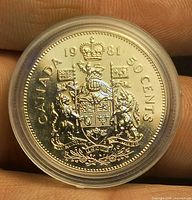 Reverse of 1981 Canadian 50-cent coin showing coat of arms inside capsule