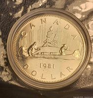 Reverse of 1981 Canadian Voyageur dollar in capsule