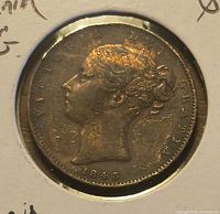 Obverse of farthing in cardboard 2x2 holder showing Queen Victoria portrait and date 1843
