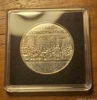Reverse of the 1982 Constitution dollar coin showing 1867 Confederation Constitution 1982 inscription within square capsule