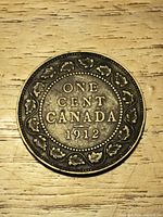 Reverse side showing ONE CENT CANADA 1912 with maple leaf wreath