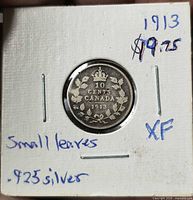 Reverse side showing 10 Cents Canada 1913 wreath and crown design in holder