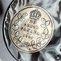 Reverse of 1918 10 cents coin in holder showing crown and wreath design