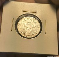 Reverse side of 1923 Canada 5-cent coin in holder
