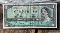 Obverse of 1954 $1 note showing serial number and portrait