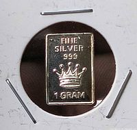Front view of .999 fine silver 1 gram bar showing crown design inside holder