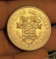 Reverse showing British Columbia shield, dogwood blossoms, legends BRITISH COLUMBIA CANADA DOLLAR 1871 1971