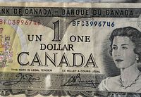 Obverse of 1973 Canadian $1 note showing denomination, Queen Elizabeth II, serial number