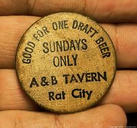 Obverse of wooden nickel showing text Good for One Draft Beer Sundays Only A&B Tavern Rat City