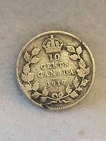 Reverse showing crown over 10 CENTS CANADA 1919 within maple leaf wreath
