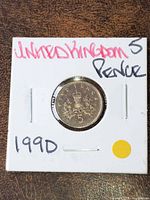 Reverse side of 1990 UK 5p coin in flip