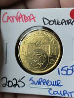 Reverse side of 2024 Canada $1 Supreme Court 150th Anniversary coin in holder
