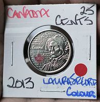 Reverse of 2013 colourized Laura Secord quarter in holder under bright light