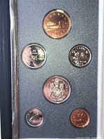 Front view of six coins in holder showing reverse designs