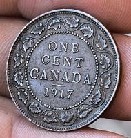 Reverse side showing ONE CENT CANADA 1917 with maple leaf wreath