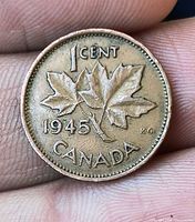 Reverse of 1945 Canadian 1 cent coin showing maple leaves, denomination and date