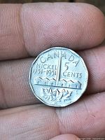 Reverse of 1951 Canada 5-cent coin with refinery design and inscriptions