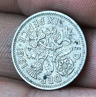 Reverse side showing SIX PENCE 1961 with floral design