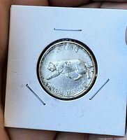 Reverse view of bobcat design, denomination and dates visible
