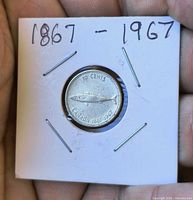 Reverse of 1967 Canadian 10 cent coin showing mackerel design in 2×2 holder