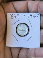 Reverse showing fish design and 10 Cents Canada 1867-1967 legend in 2×2 holder