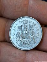 Reverse: Canadian coat of arms, date 1986, denomination 50 cents