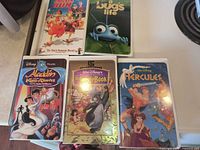 Front covers of all five sealed VHS tapes displayed