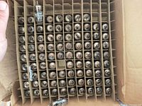 Top view showing grid of over 100 vacuum tubes in cardboard dividers