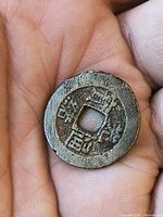 Obverse side of bronze cash coin showing Chinese characters and square hole