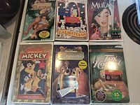 Front covers of all six sealed Disney VHS tapes displayed in two rows