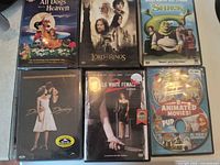 Front covers of six sealed DVDs