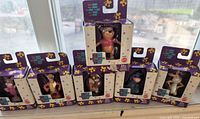 Front view of six sealed figurines showing characters and packaging
