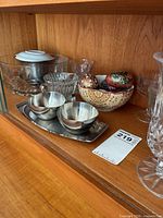 Assorted glass items, stainless condiment set, ceramic eggs in bowl
