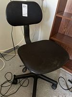 Full view of chair showing seat, backrest, base and casters