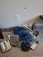 Pile showing bases, handset, Logitech receiver and cables