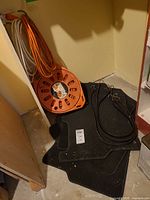 Lot overview showing reel, bungee cords and floor mats