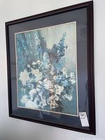 Full view of framed floral print on wall