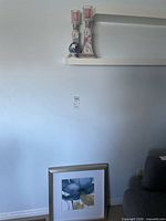 overview showing both candlesticks, egg on shelf, framed print below