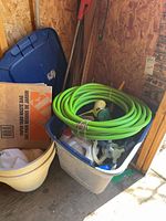 Overview of tote, hose, planters, broom handle visible